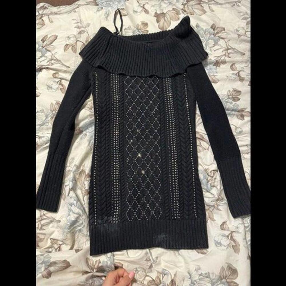 Bebe Sweater with an off-the-shoulder Black Ringstone design